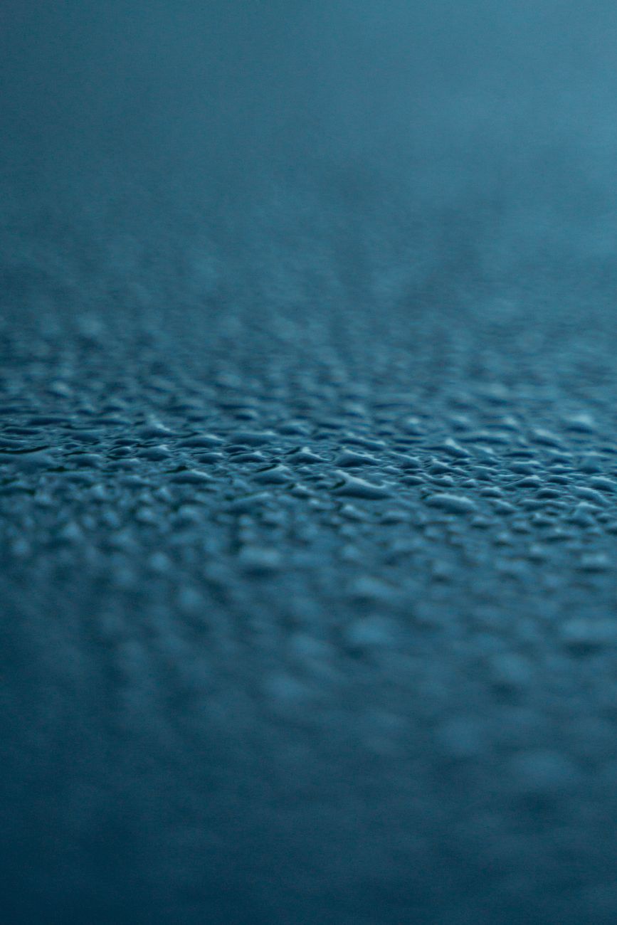 Macro close-up of ceramic coating water beading on car paint